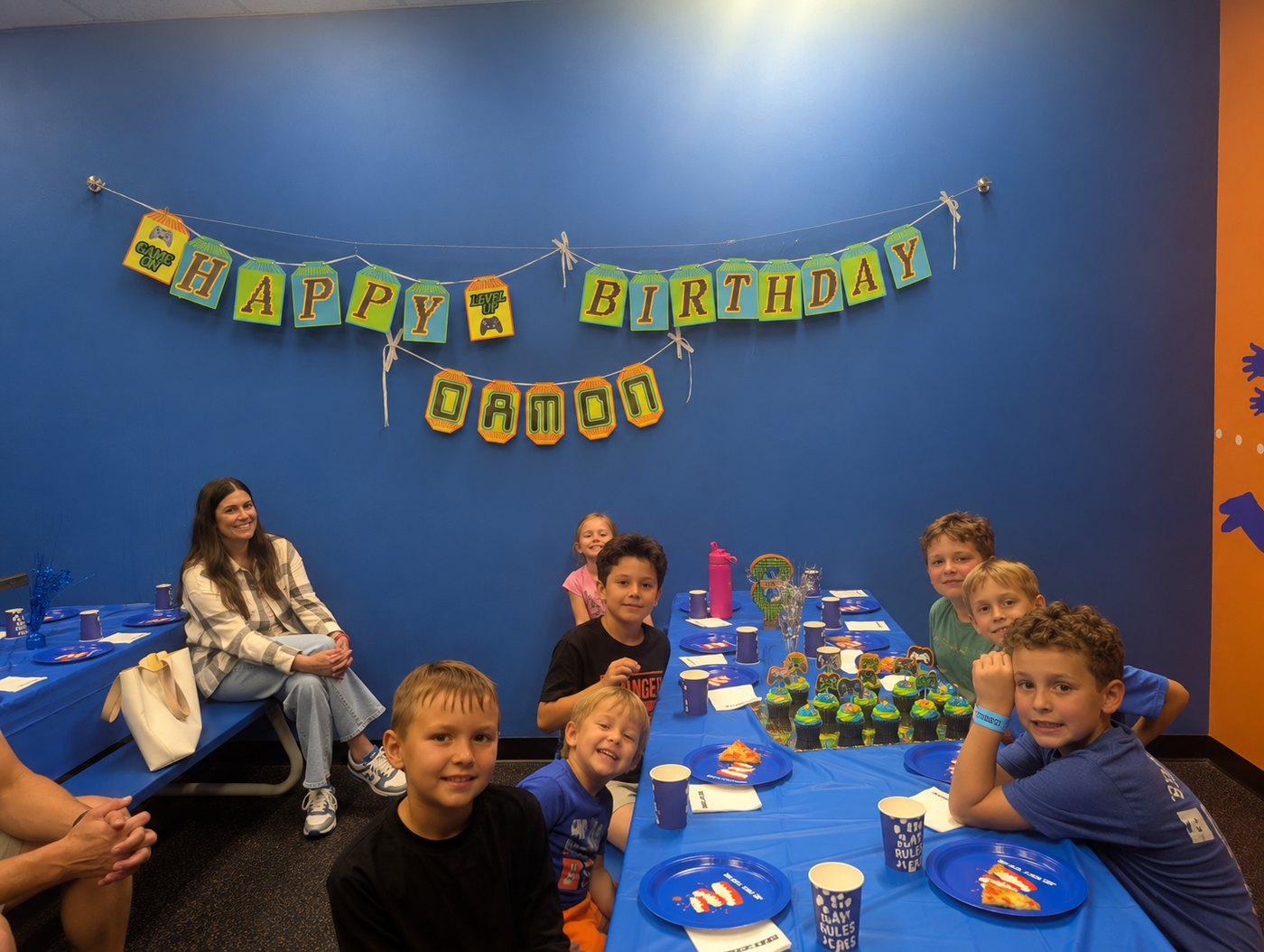 A Video Gamer Happy Birthday banner and a DAMON name banner hung over a party table